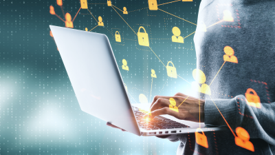 Man solving cybersecurity threat on a laptop