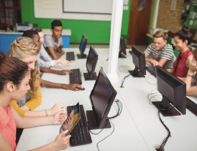 Students learning at compmuters in a classroom